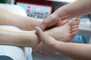 Podiatrist examining patient’s foot during a consultation for everyday podiatry foot pain relief
